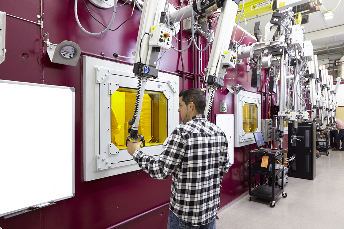 A researcher operates a hot cell's mechanical arms inside the Centre for Advanced Nuclear Systems.