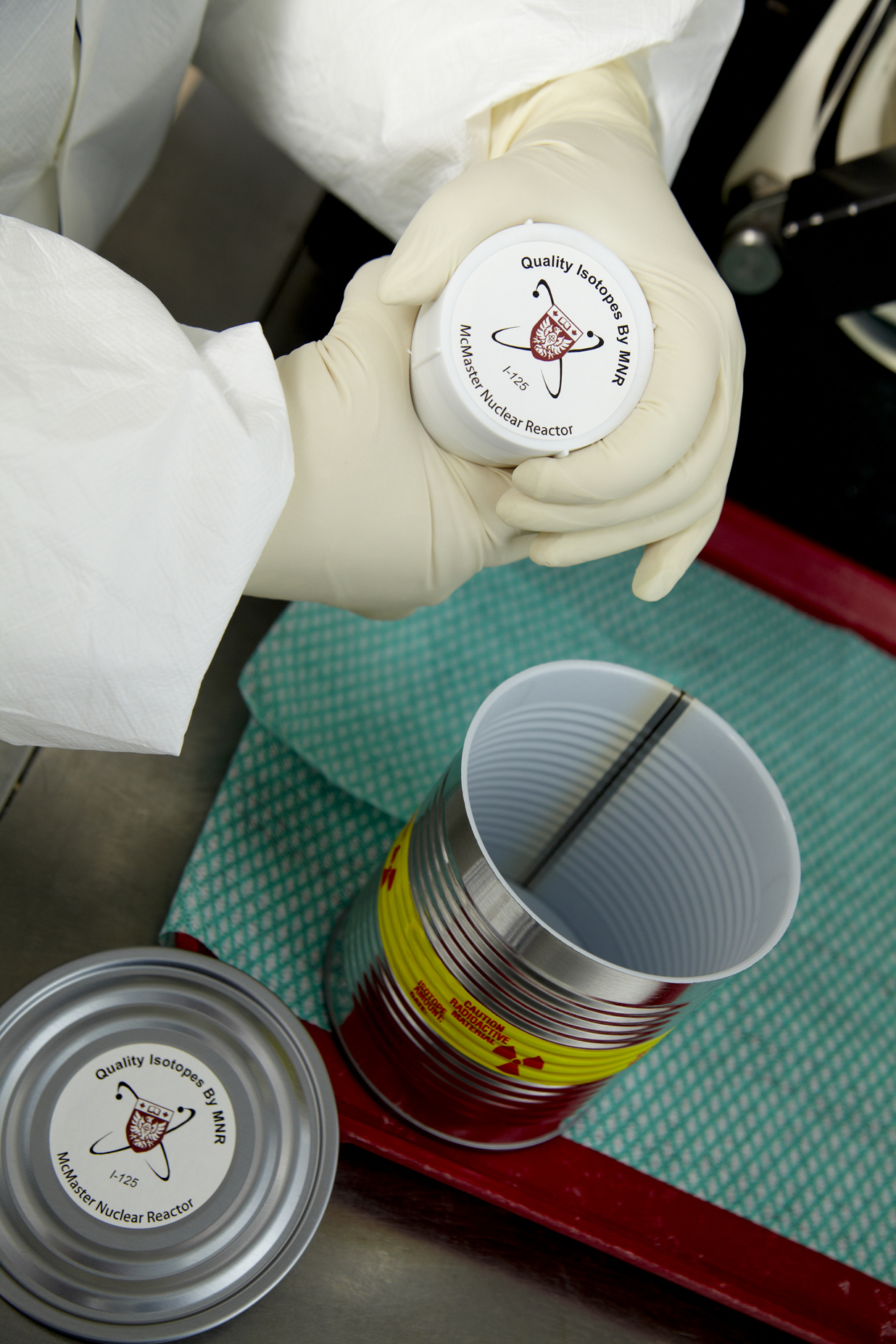 A technician holds a bottle containing medical isotope iodine-125.