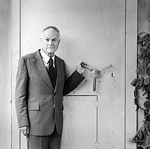 Harry Thode stands next to the McMaster Nuclear Reactor air-lock door.