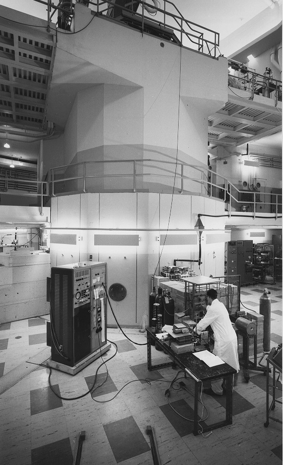 A researcher uses equipment inside the McMaster Nuclear Reactor, circa 1960.