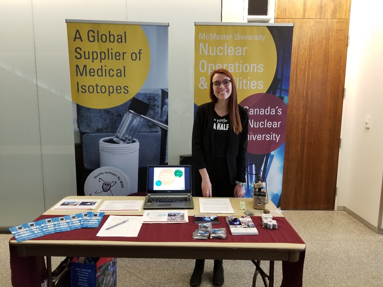 Sarah Aubert stands behind NOF's table at the OAPT.