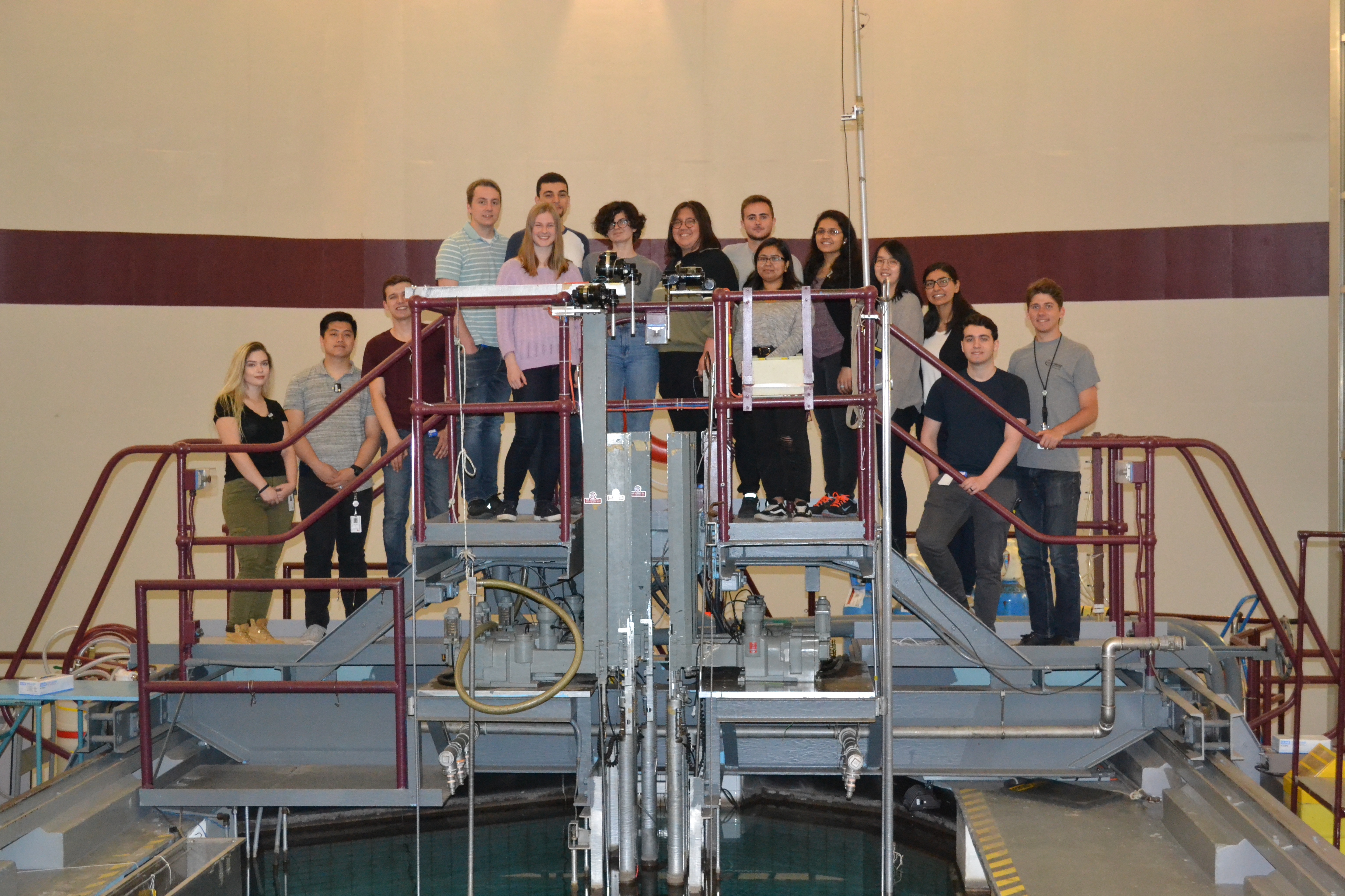 MNR summer students stand on the bridge overlooking the McMaster Nuclear Reactor pool.