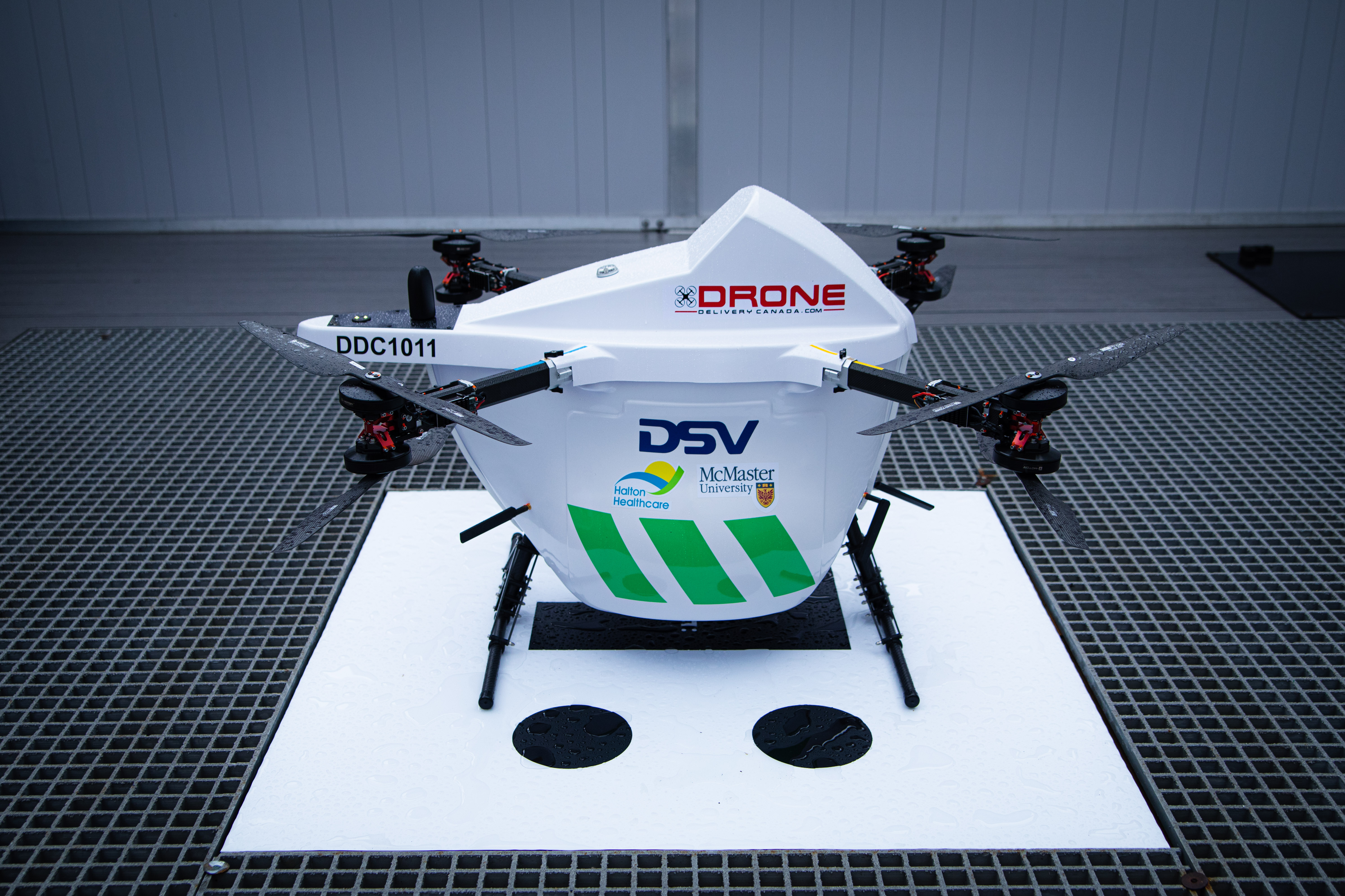A drone sits on a landing pad.