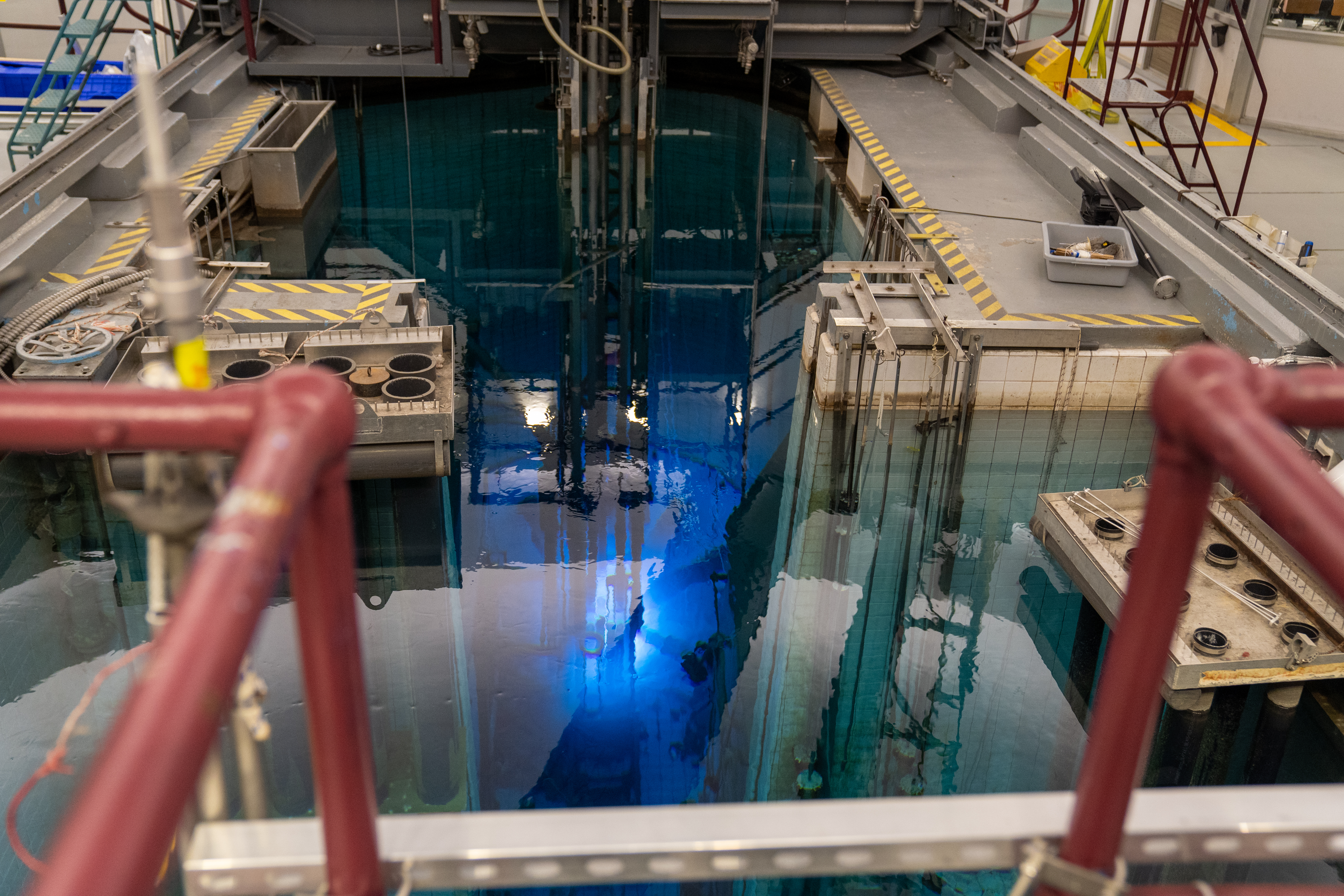 View of the McMaster Nuclear Reactor core, which glows blue.