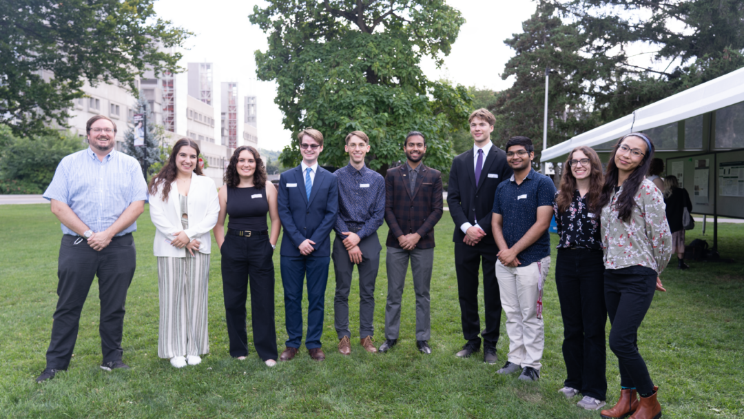 Students and mentors in the CNL nuclear research program stand on lawn outside McMaster.