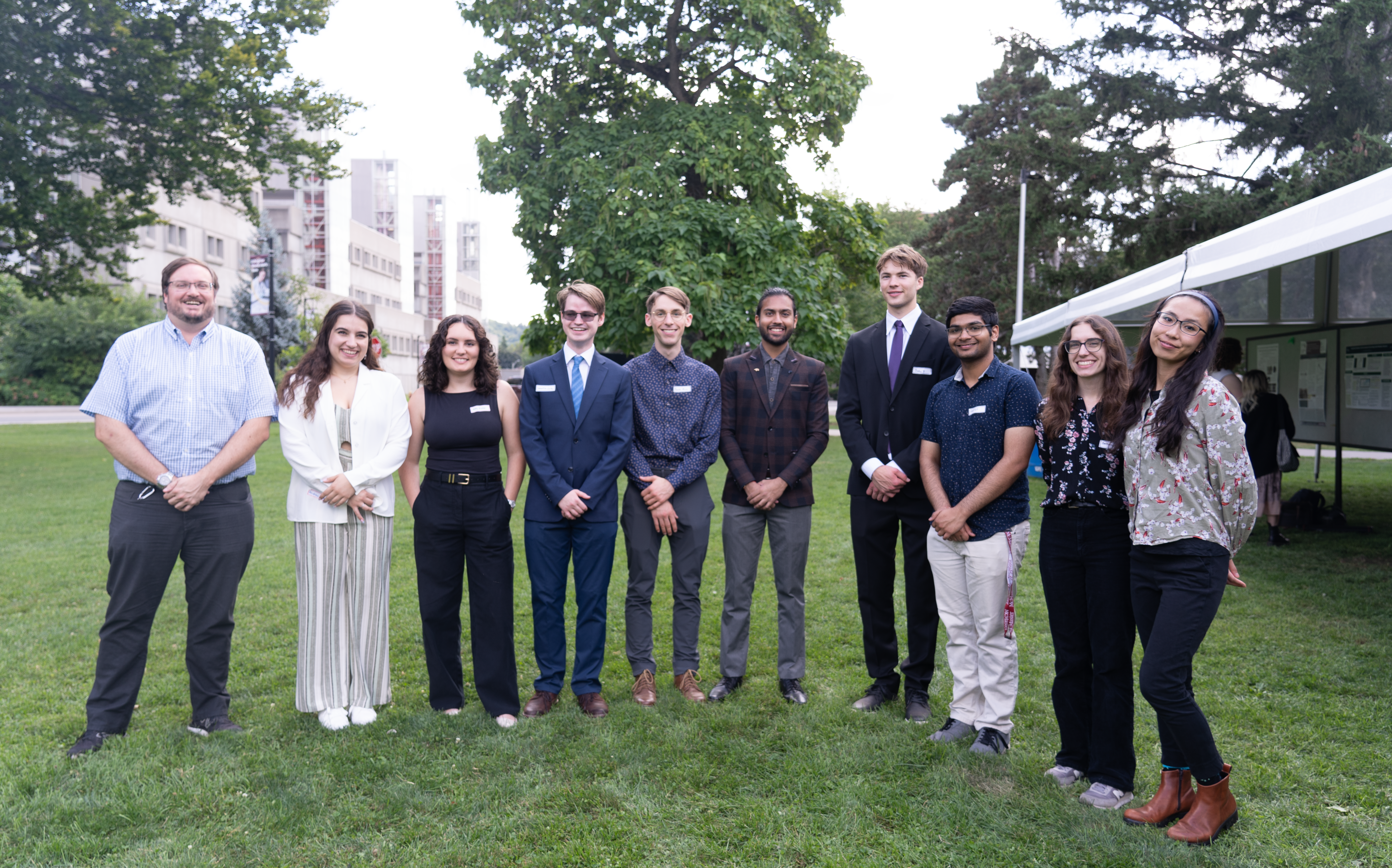 Students and mentors in the CNL nuclear research program stand on lawn outside McMaster.